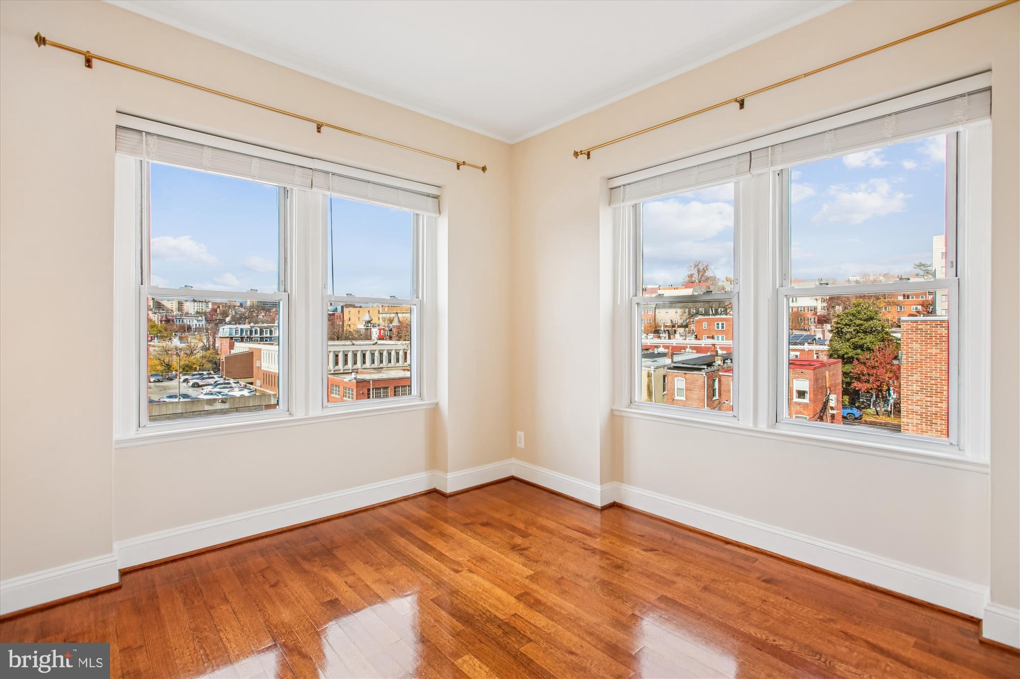 2008 16th Street Northwest, Unit 402 Washington, DC 20009 - Photo 9 of 34 a view of an empty room with a window and wooden floor