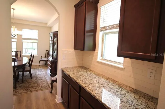 a kitchen with granite countertop a sink and a wooden floor