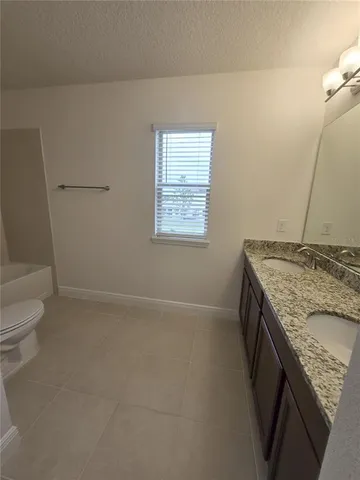 a large bathroom with a large tub and sink