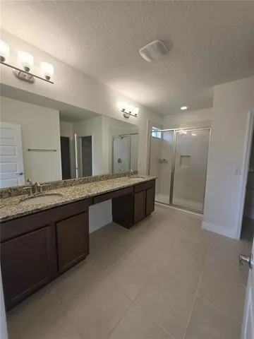 an empty room with windows and ceiling fan