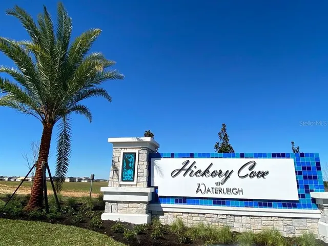 a sign that is sitting on a brick wall and a big window