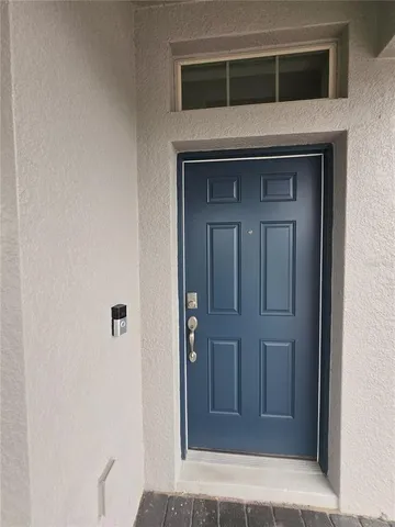 a view of an ocean with a floor to ceiling window and an outdoor space