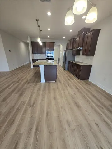 a kitchen with sink and chairs
