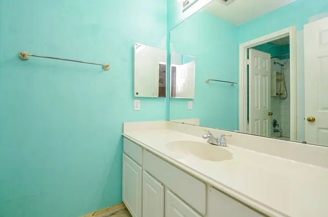 a bathroom with a sink and a mirror