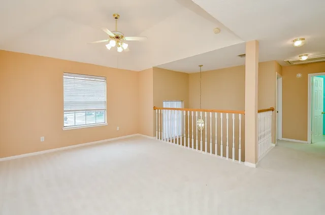 a view of a livingroom with a ceiling fan and window