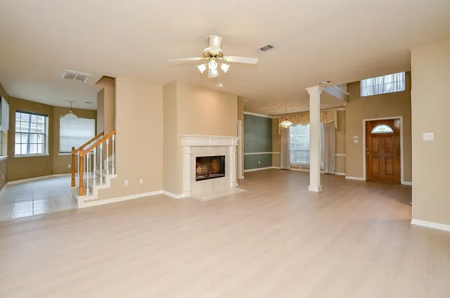 a view of a livingroom with an empty space and a fireplace
