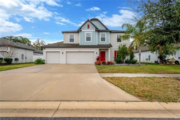 a front view of a house with a yard and garage
