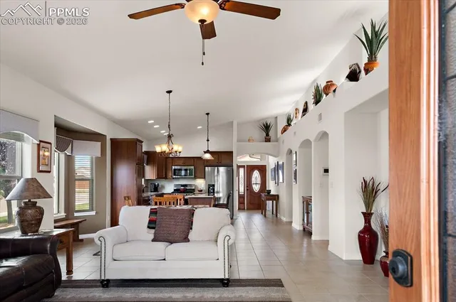 a living room with furniture and a chandelier