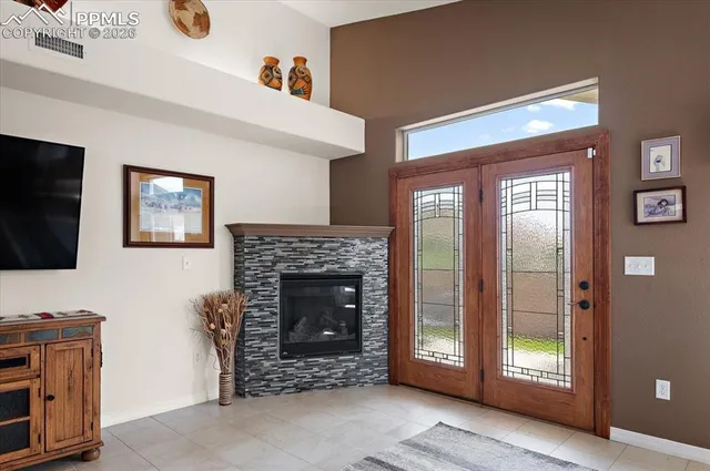 a living room with furniture a flat screen tv and a fireplace