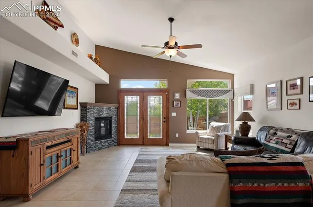 a living room with furniture a flat screen tv and a fireplace