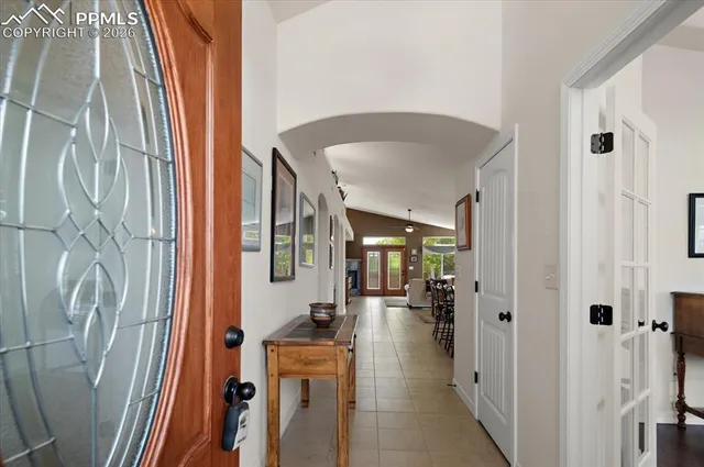 a view of a hallway with a livingroom and a bathroom