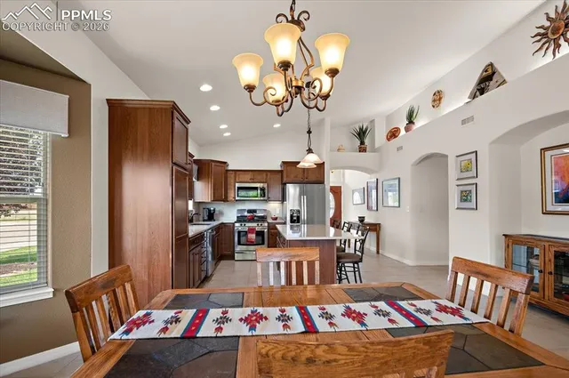 a bedroom with a bed ceiling fan and a window