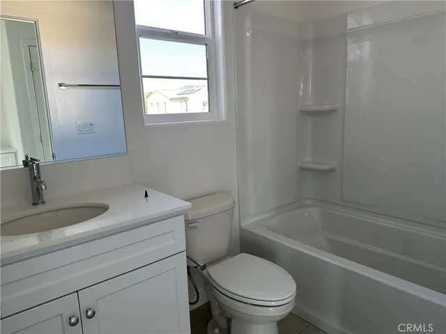a bathroom with a granite countertop toilet a sink and a bathtub