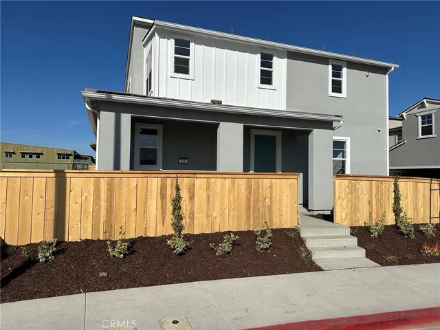 a view of a house with car parked