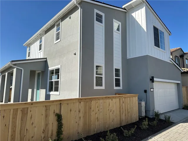 a view of a house with a wooden fence