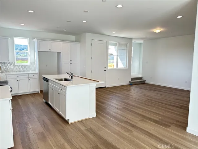 a view of kitchen with wooden floor and electronic appliances