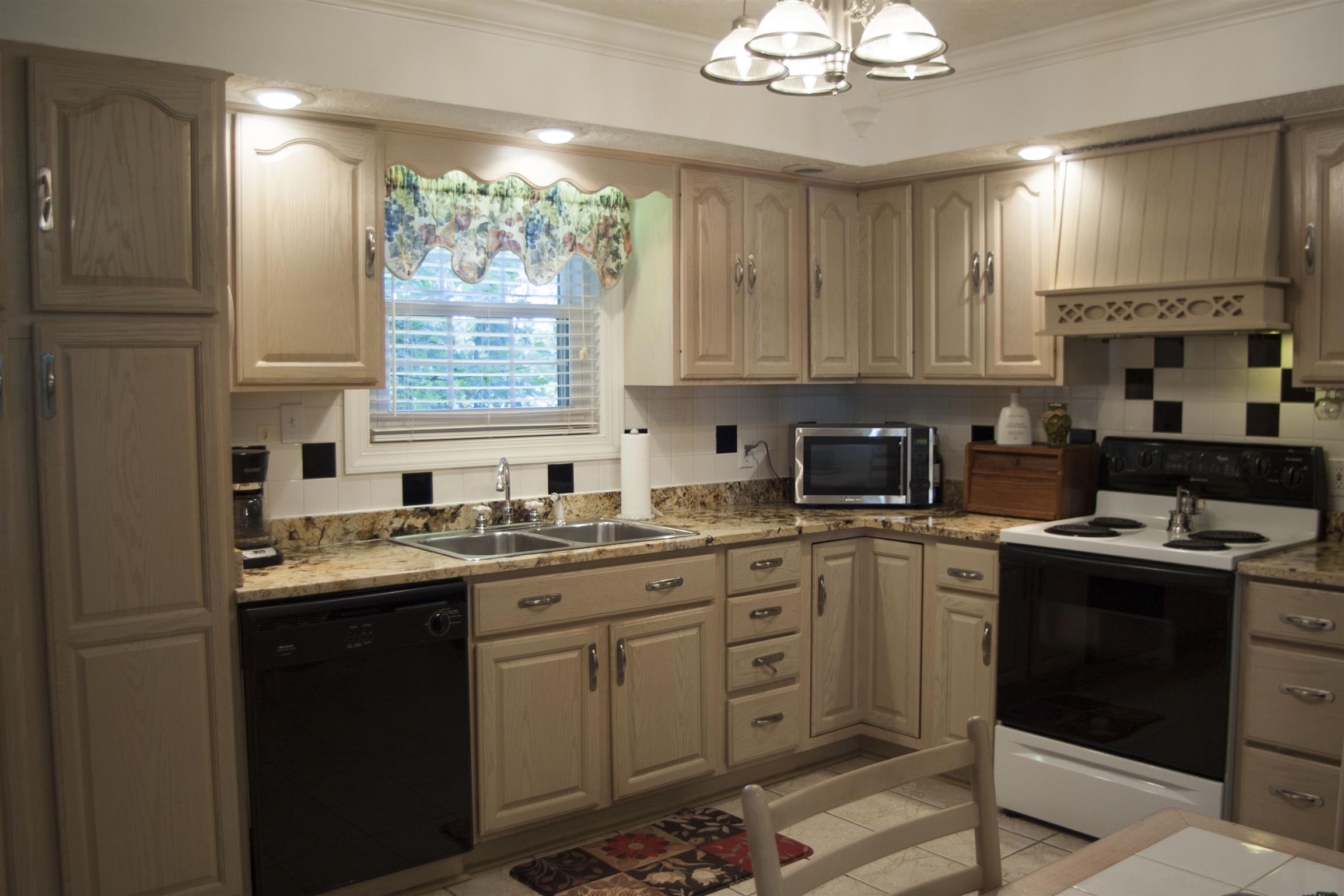 984 Dixie Bee Road Adams, TN 37010 - Photo 9 of 18 a kitchen with a sink stove and cabinets