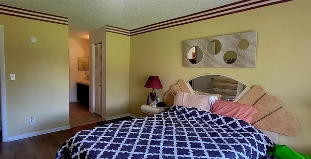 a bedroom with a bed and a painting on the wall