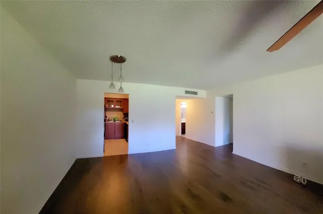 a view of a room with wooden floor and window