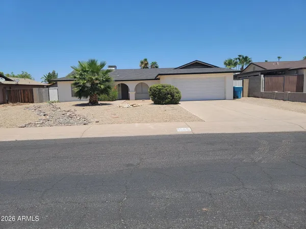 a kitchen with stainless steel appliances granite countertop a stove top oven a sink a dining table and chairs