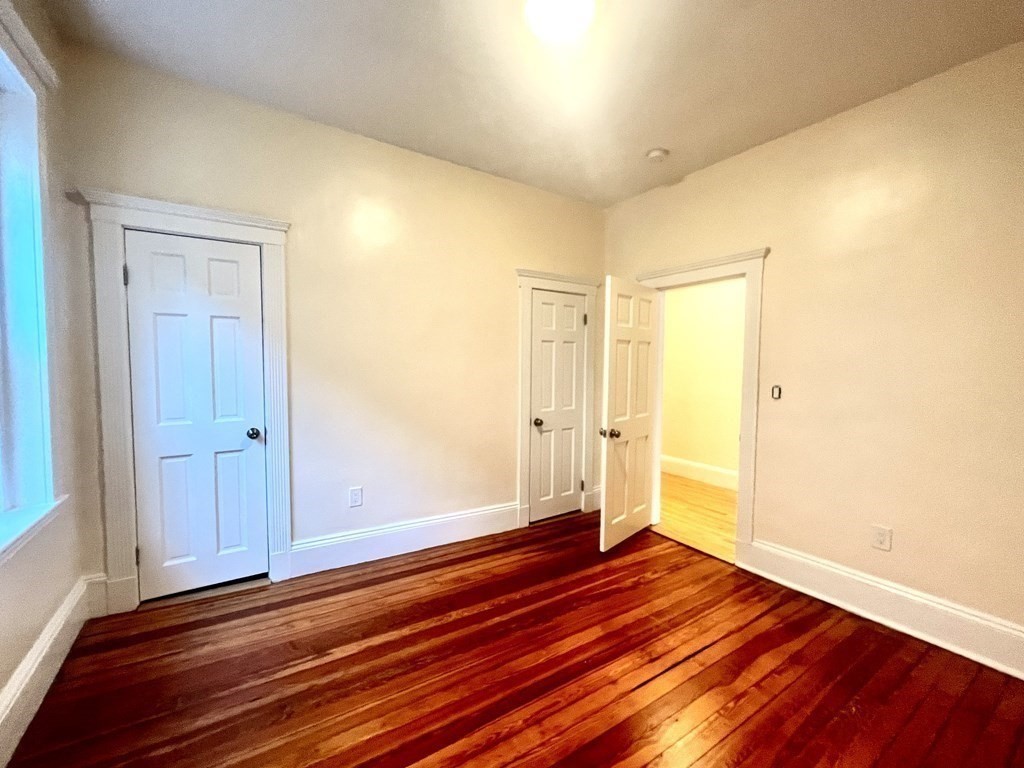 102 Trowbridge Street, Unit 2L Cambridge, MA 02138 - Photo 7 of 16 a view of empty room with wooden floor