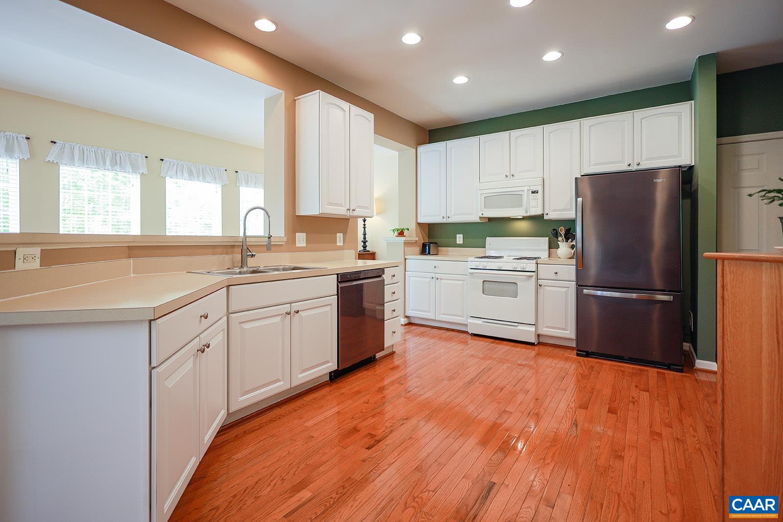5372 Park Road Crozet, VA 22932 - Photo 7 of 54 a kitchen with a refrigerator a sink and white cabinets
