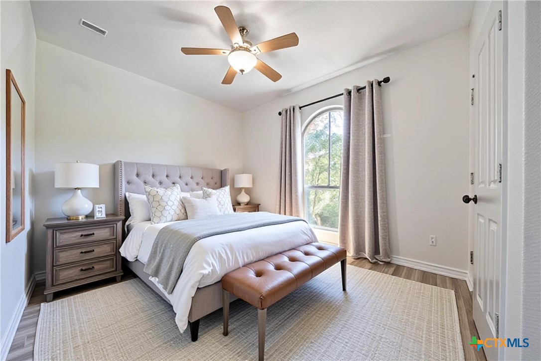 519 Long Meadow Spring Branch, TX 78070 - Photo 18 of 33 a bedroom with a bed a window and a chandelier