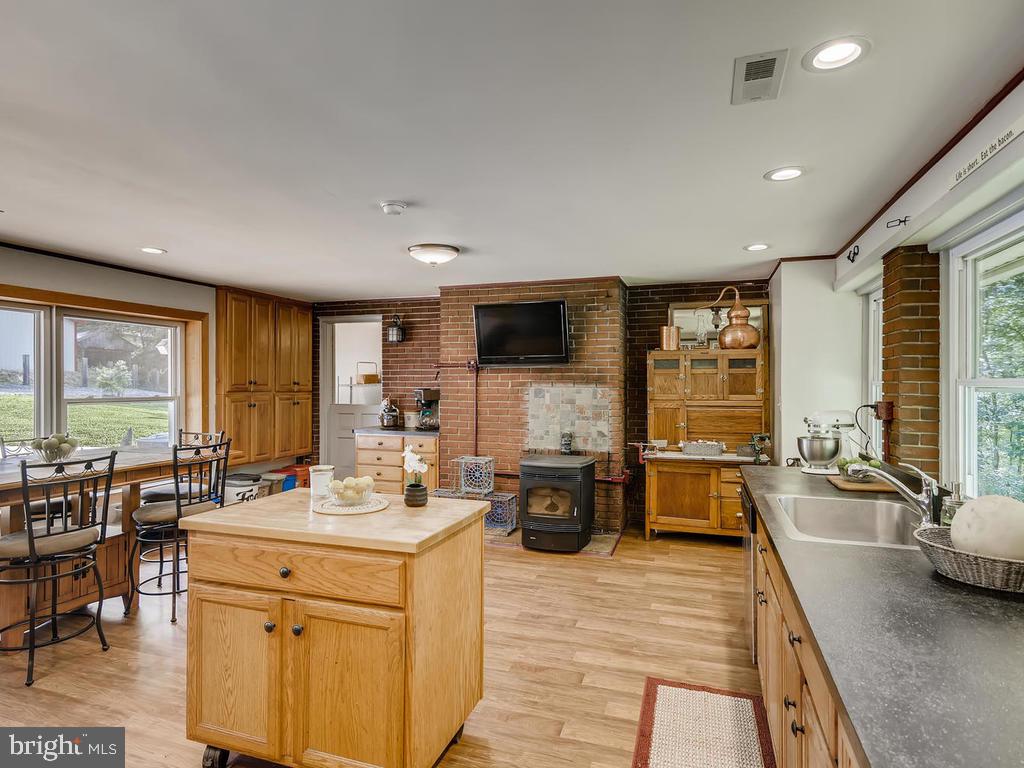 1200 Whitaker Mill Road Joppa, MD 21085 - Photo 8 of 48 Kitchen Island and Pellet Stove in Back