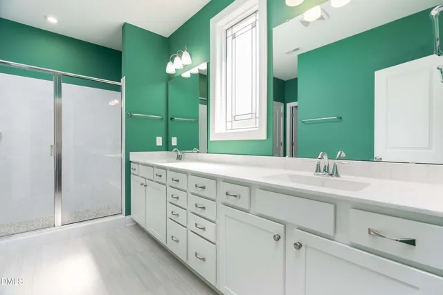 a bathroom with a double vanity sink and a mirror