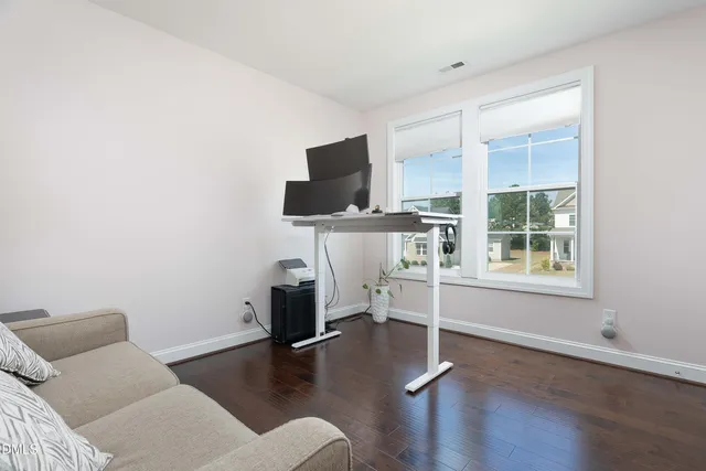 a bed sitting in a bedroom next to a window