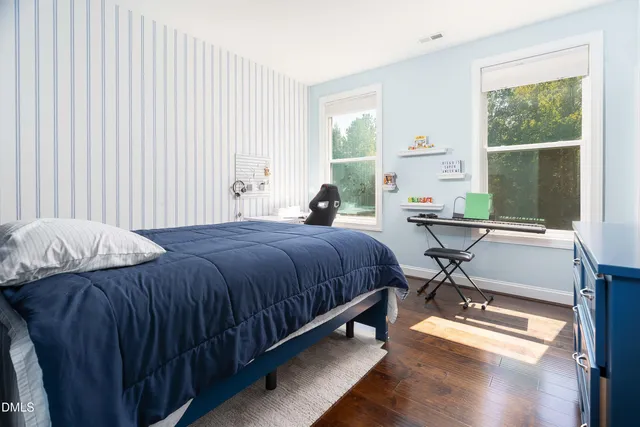 a bedroom with a bed and a chair