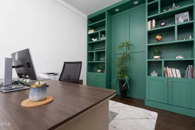 a view of a workspace with furniture and a window