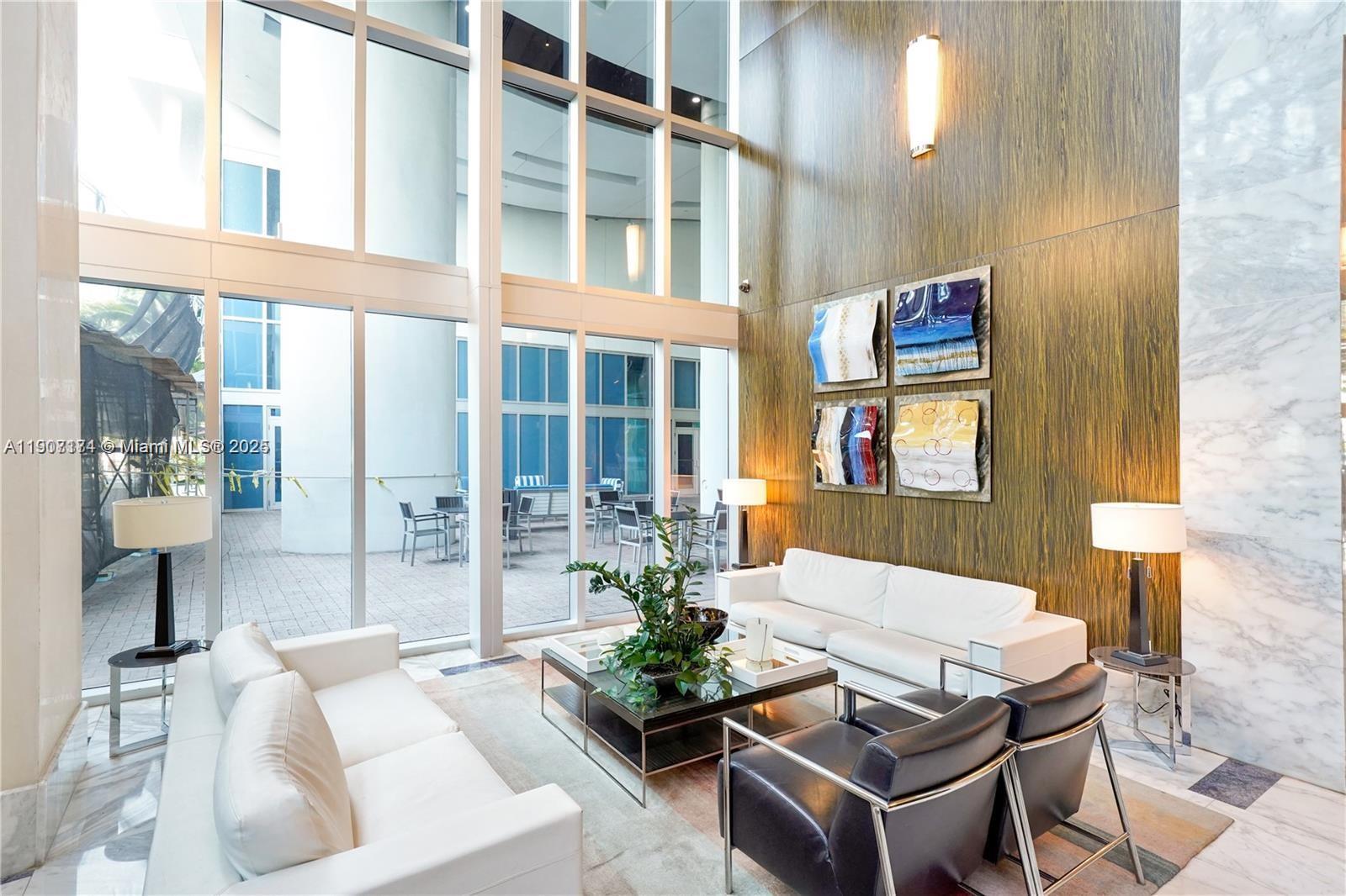 185 Southwest 7th Street, Unit 3100 Miami, FL 33130 - Photo 12 of 19 a living room with furniture and a potted plant