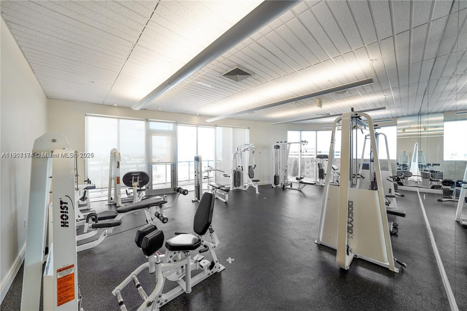 185 Southwest 7th Street, Unit 3100 Miami, FL 33130 - Photo 16 of 19 a room with lots of tables a large window and furniture