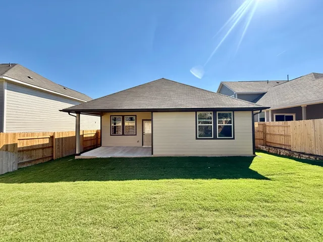 a view of a house with a yard and sitting area