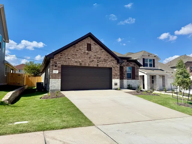 a front view of a house with a garden