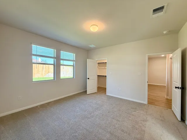 an empty room with windows and closet
