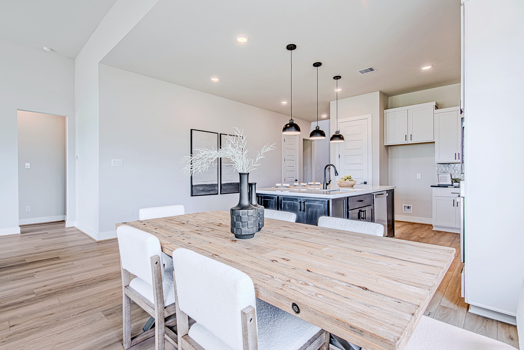 141 Peninsula Point Drive Montgomery, TX 77356 - Photo 14 of 47 The dining area offers a seamless connection to the kitchen and island bar seating, all wrapped in soft light from the oversized windows.