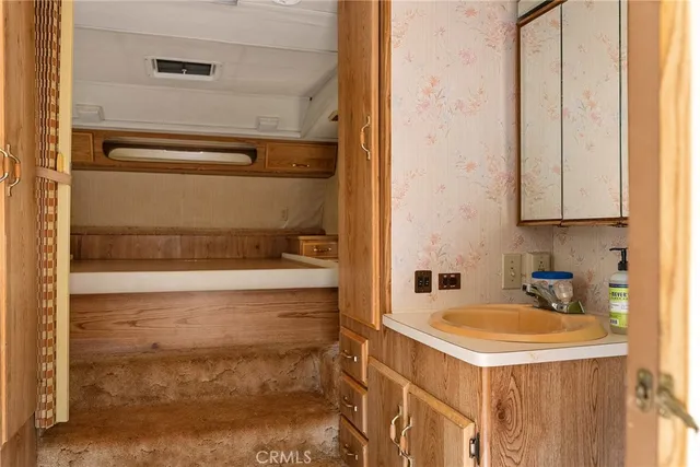a kitchen with refrigerator and window