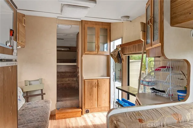 a living room with stainless steel appliances furniture and a window