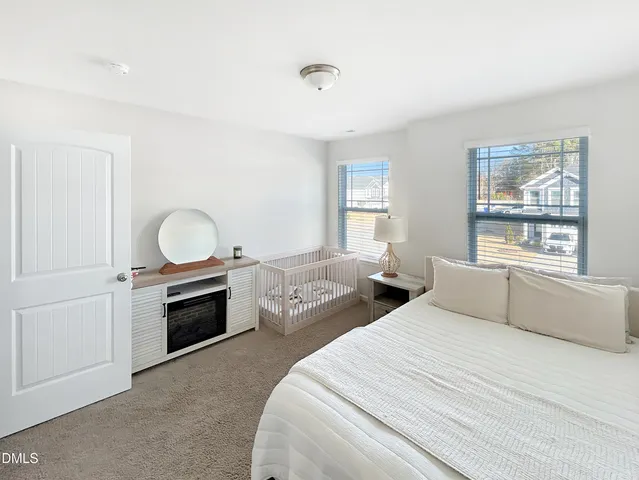 a bed room with two beds and a window