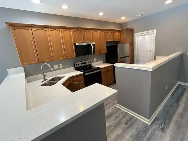a kitchen with stainless steel appliances granite countertop a sink counter space and cabinets