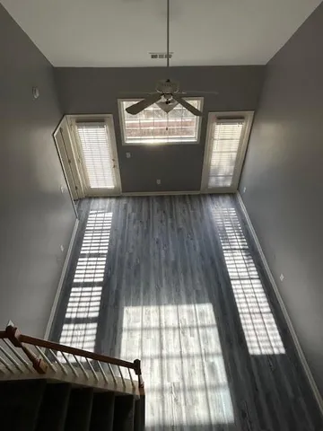 wooden floor in a hall with a window