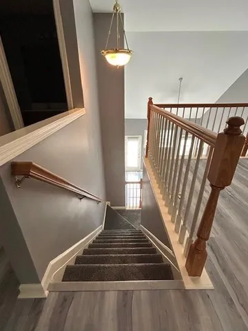 an empty room with wooden floor and closet