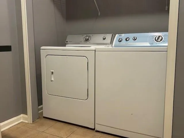 a view of a room with wooden floor and a bathroom