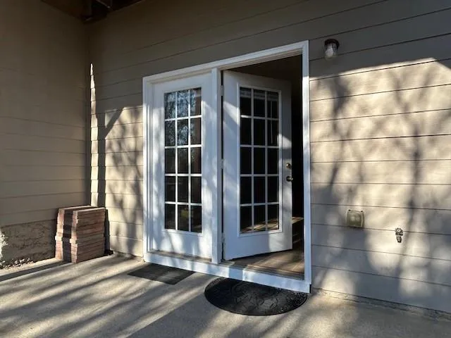 a view of a room with a ceiling fan and window