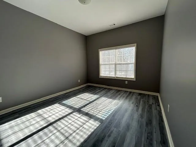 a view of a roof deck with couches and wooden floor
