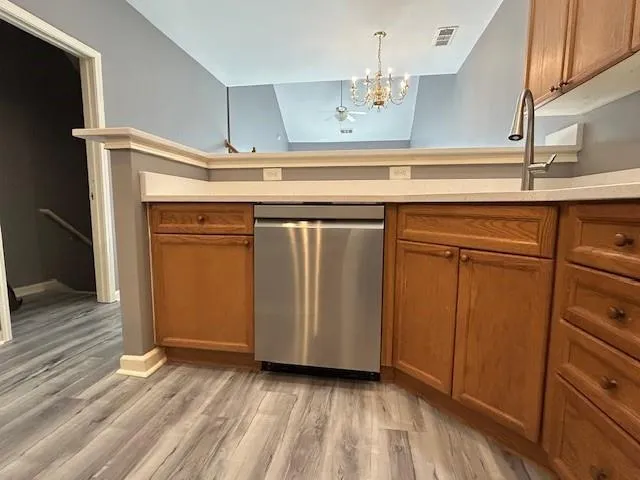a view of a kitchen with wooden floor and cabinets