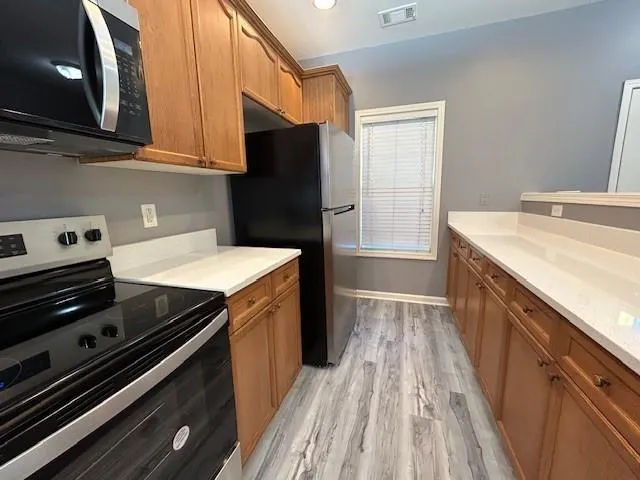a kitchen with a stove and a refrigerator