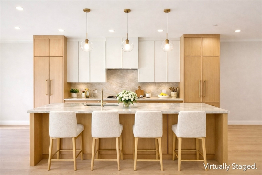 a kitchen with cabinets and chairs